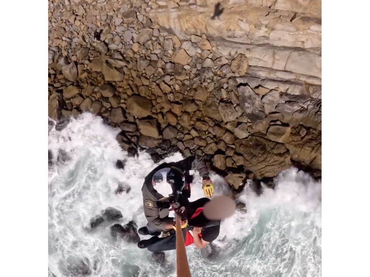 After the fisherman climbed out of the water, rescuers used a caller’s GPS coordinates to find him.