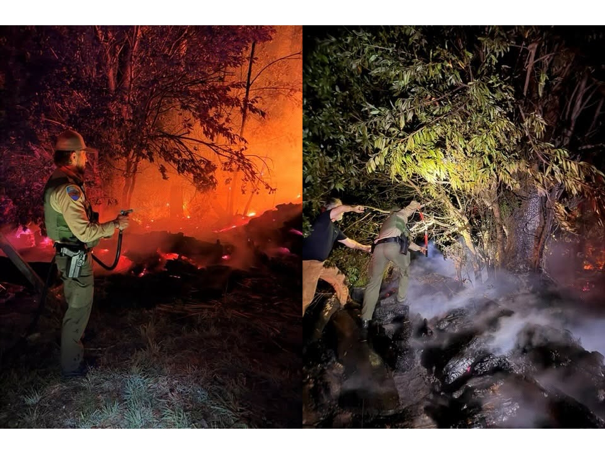 Marin County deputies help hold back a fire moving toward a home and other properties early Friday in Inverness until firefighters arrived.