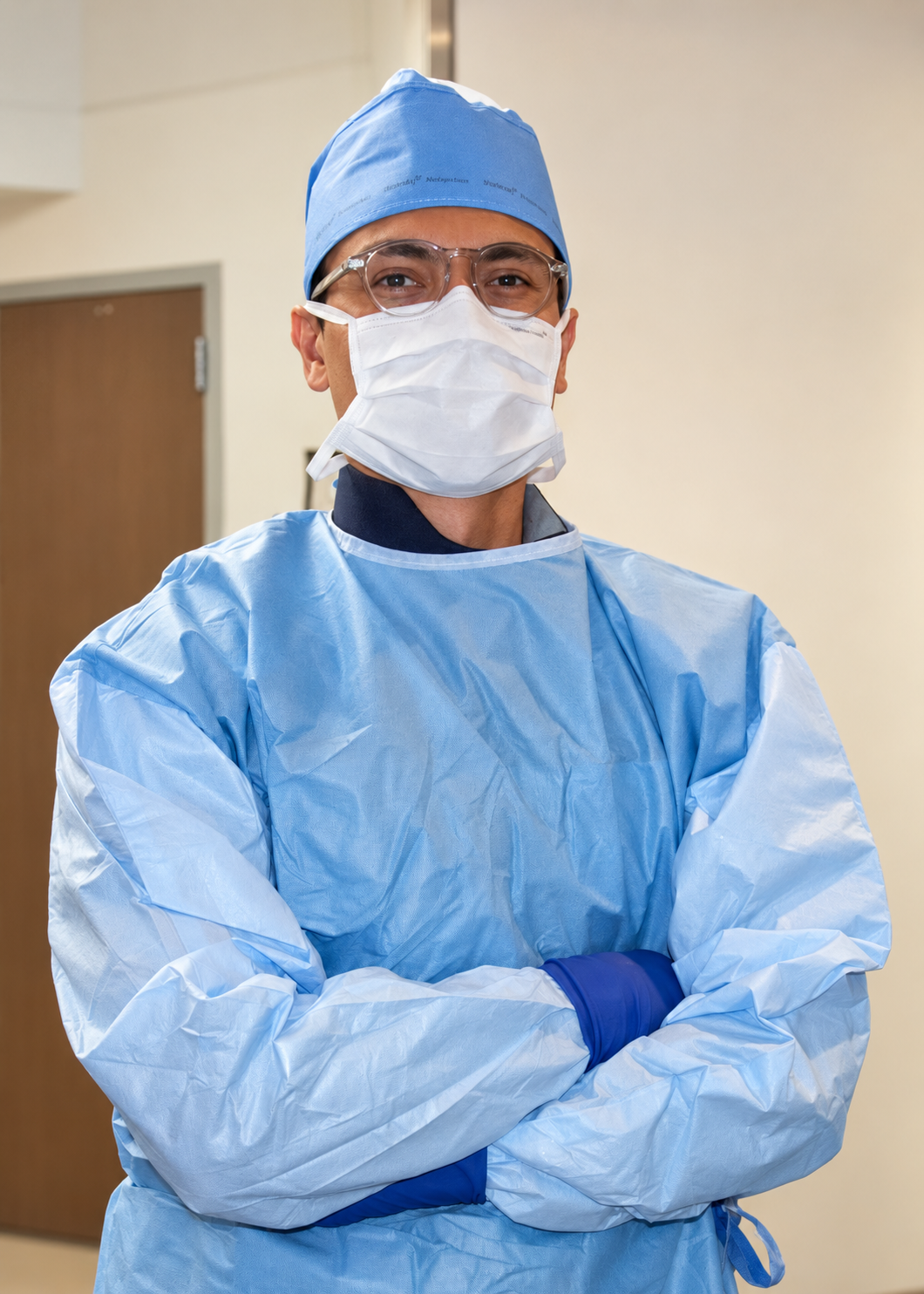 A male surgeon wearing full PPE