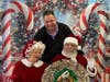 Sal Mangano, President of Mangano Family Funeral Homes, visits with Santa and Mrs. Clause while stopping by the Spangle Drive Senior Center’s Christmas luncheon to deliver scratch-off lottery tickets to the guests in attendance. 