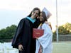 Principal Dr. Deborah Brand congratulates a member of the Class of 2026 as graduates crossed the stage on Harold “Doc” Rasbeck Field.