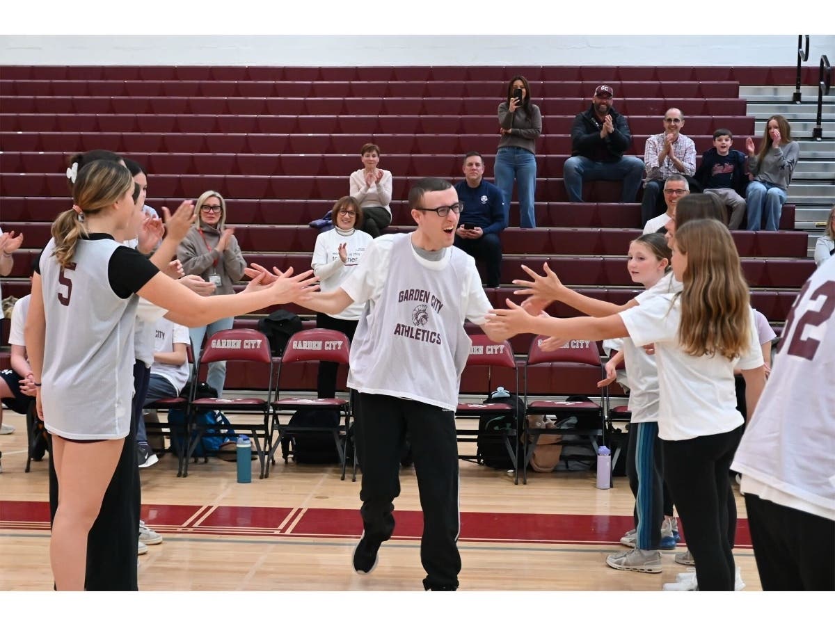 A Challenger basketball team member received high fives before the start of the game.