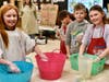 Elementary students at Academy Street Elementary School tie-dye colorful socks during an art class in preparation for the district’s Rock Your Socks disability awareness campaign.