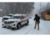 Emergency vehicles from the Smithtown Department of Public Safety and Nesconset Fire Department line the roadway near Gibbs Pond as crews respond to an ice rescue.