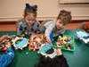 Prekindergarten students at Marion G. Vedder Elementary School work together during a hands-on winter activity station designed to strengthen coordination and early learning skills.