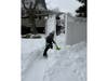 Savannah Hoffman helps shovel snow alongside other neighbors as volunteers worked for several hours to dig out homes across Babylon Village.