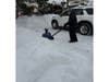 Jordan Hoffman uses a snow blower to clear a driveway as part of a volunteer effort organized by Babylon Village residents after the storm.
