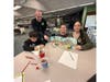 A Daniel Street Elementary second grader works alongside a Lindenhurst Middle School student as part of a collaborative monster-themed art project held in the middle school library.