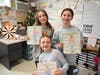 Sixth-grade students at West Babylon Junior High School hold books and character analysis posters during an English class project.