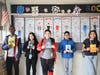 West Babylon students display colorful “body biography” character posters on a classroom wall.