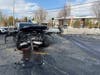 A heavily damaged SUV sits in the roadway following a collision at Route 347 and Route 111 in Smithtown as crews investigate.