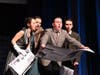 Cast members react to a breaking news moment during a musical number in West Babylon Senior High School’s production of “Curtains.”