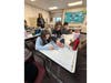 Students work together to create “melted snowman” crafts during a joint ENL and life skills lesson.
