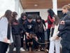 Smithtown High School East Student Leadership students gather around Shiloh, an adoptable Rottweiler from the Smithtown Animal Shelter, during a visit tied to the “A Scoop for Love” Valentine’s Day outreach event in St. James.