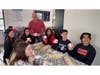 Teacher Joe Toth and Smithtown High School East Student Leadership students hold Valentine’s Day adoption stickers they created to promote long-term shelter pets as part of the “A Scoop for Love” initiative at Mickey’s Ice Cream Kitchen.