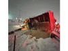 A New York State Department of Transportation snowplow lies overturned after striking a guardrail on westbound Sunrise Highway near Exit 44 Sunday night. The driver was not injured, police said.