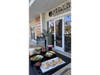 Sandwiches, salads, pastries, and specialty drinks are displayed outside a Pilar Coffee Bar storefront. Three Long Island locations are currently under construction.
