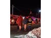 Residents are assisted away from the scene as firefighters battle a working fire at Fairfield Suburbia Gardens on Great East Neck Road in West Babylon on Sunday night.