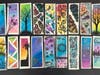 A collection of student-designed bookmarks featuring inspirational messages and colorful artwork prepared for donation.
