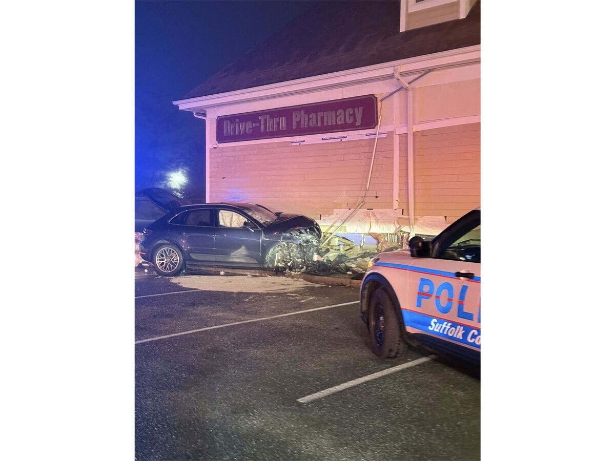 Emergency responders investigate structural damage after a Porsche crashed into the CVS on West Main Street in Sayville early Sunday morning, according to Suffolk County police.