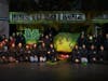 Central Islip High School staff who worked behind the scenes on the production of “Little Shop of Horrors” pose on stage with the show’s elaborate set and prop plant during the March performances. 