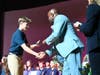 A student receives a certificate of induction during the National Junior Honor Society ceremony at Beach Street Middle School on March 16.