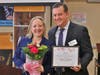 Suffolk County Legislator Rebecca Sanin is honored during the Suffolk Y JCC’s Women of Valor celebration, receiving a certificate and flowers alongside CEO Rick Lewis.