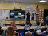 A pilot shares experiences and answers student questions during Career Week at Paul J. Bellew Elementary School.