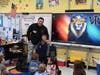 A guest speaker engages with students during a Career Week classroom visit at Paul J. Bellew Elementary School.
