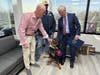 U.S. Marine veteran Mike Kilano and service dog Nova visited the Bohemia office of Miller & Caggiano, LLP, where staff learned about the impact of Paws of War’s programs.
 