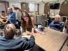 Smithtown High School East students spend time with residents, offering companionship through conversation and activities.