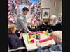 Smithtown High School East students play games and connect with residents during a visit to a local assisted living facility.
