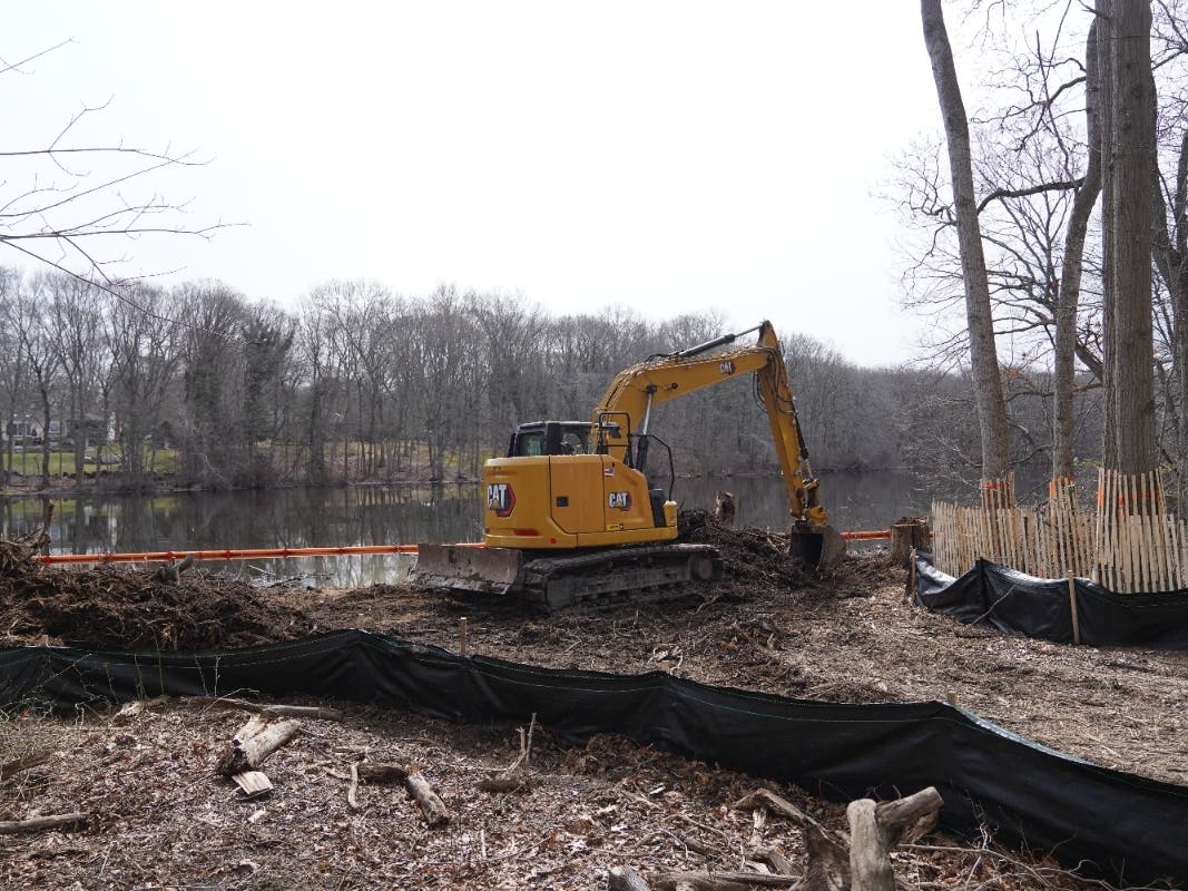Construction is underway on a new drainage pipe and weir system at Millers Pond in Smithtown.