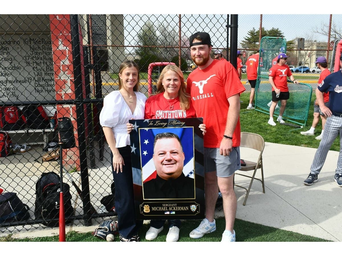 The Smithtown East and West varsity baseball teams honored Michael
“Mick” Ackerman, the late husband of Smithtown Schools Board of Education member
Bernadette Ackerman, before their game on April 16,