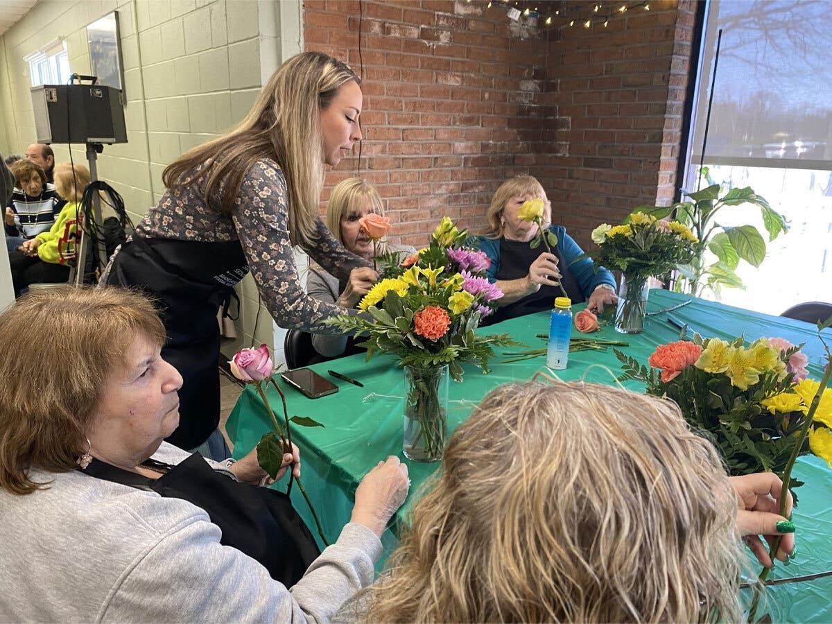 Kim Mangano of Mangano Family Funeral Home and Family Florist
helping students with their floral arrangements.