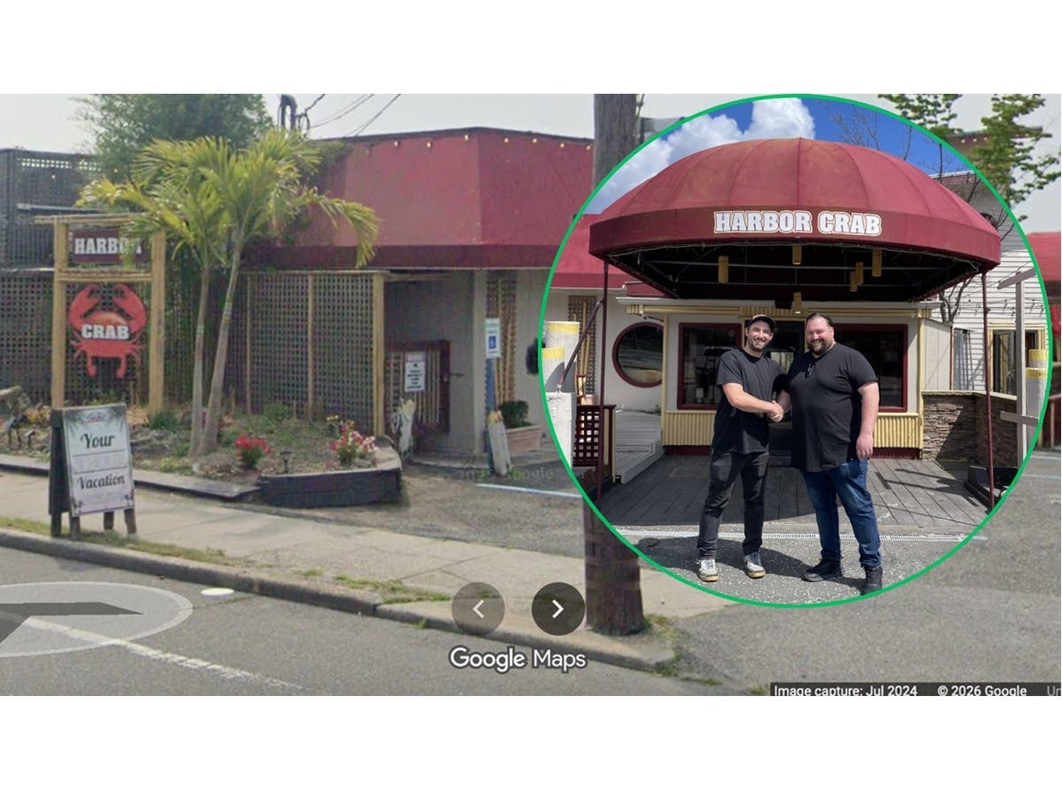 Jay Varney, left, and Will Strano stand outside the former Harbor Crab Co. site in Patchogue, where they plan to open Bayman’s Clam Bar by Memorial Day.