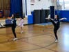 The Bayport-Blue Point High School dance team leads second- and third-grade students through a warmup exercise at Blue Point Elementary.  