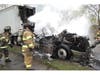 Hauppauge Fire Department crews advance a hose line toward a burning tractor-trailer, working through heavy smoke conditions to bring the blaze under control.