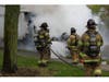 Firefighters work to extinguish a heavily damaged tractor-trailer after a fire broke out along Veterans Highway in Hauppauge. Crews used hose lines to knock down remaining hot spots as smoke continued to rise from the cab.
