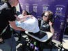 Students from the People’s Arc of Suffolk Educare Center participate in a “fire brigade”-style line, passing donated clothing during a kickoff event for a new partnership with Big Brothers Big Sisters of Long Island in Bohemia.