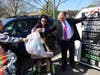 Leaders from People’s Arc of Suffolk and Big Brothers Big Sisters of Long Island help deposit donated clothing into a newly installed donation bin as students assist during the program’s launch event in Bohemia.