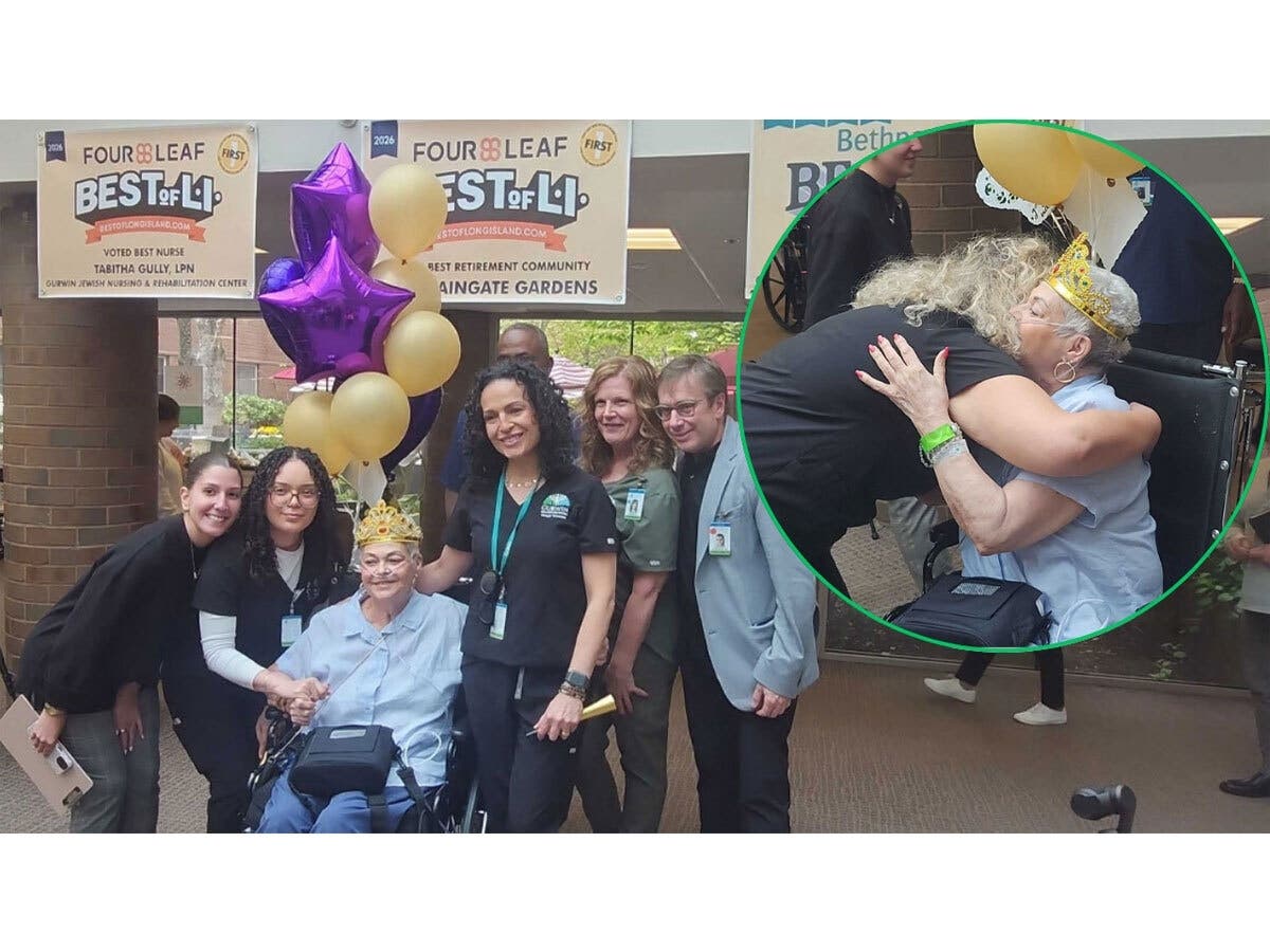 Roseann Iavarone poses with members of her care team during a celebratory “clap out” at Gurwin Jewish Nursing & Rehabilitation Center in Commack on Monday.