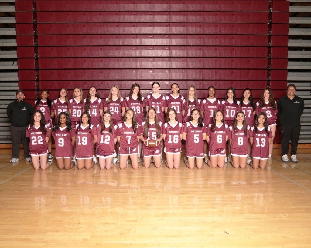 Walt Whitman Wildcats Varsity Girls Flag Football Team with Head Coach Ralph Milazzo (far left) and Assistant Coach Robin Rosa (far right).