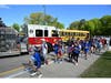 Students gather around a Smithtown fire truck outside Mt. Pleasant Elementary School as Field Day begins following Nora Tarello’s winning “Ride to School” experience.  