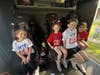 Students smile inside Engine 4-2-4 during a special ride to Mt. Pleasant Elementary School after Nora Tarello won the “Fire Truck Ride to School” PTA fundraiser experience. Photo credit: Smithtown Fire Department
