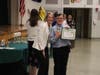 Oldfield Middle School Principal Maribeth Corr congratulates a student recipient during the school’s 20th Annual All-Star Awards ceremony.