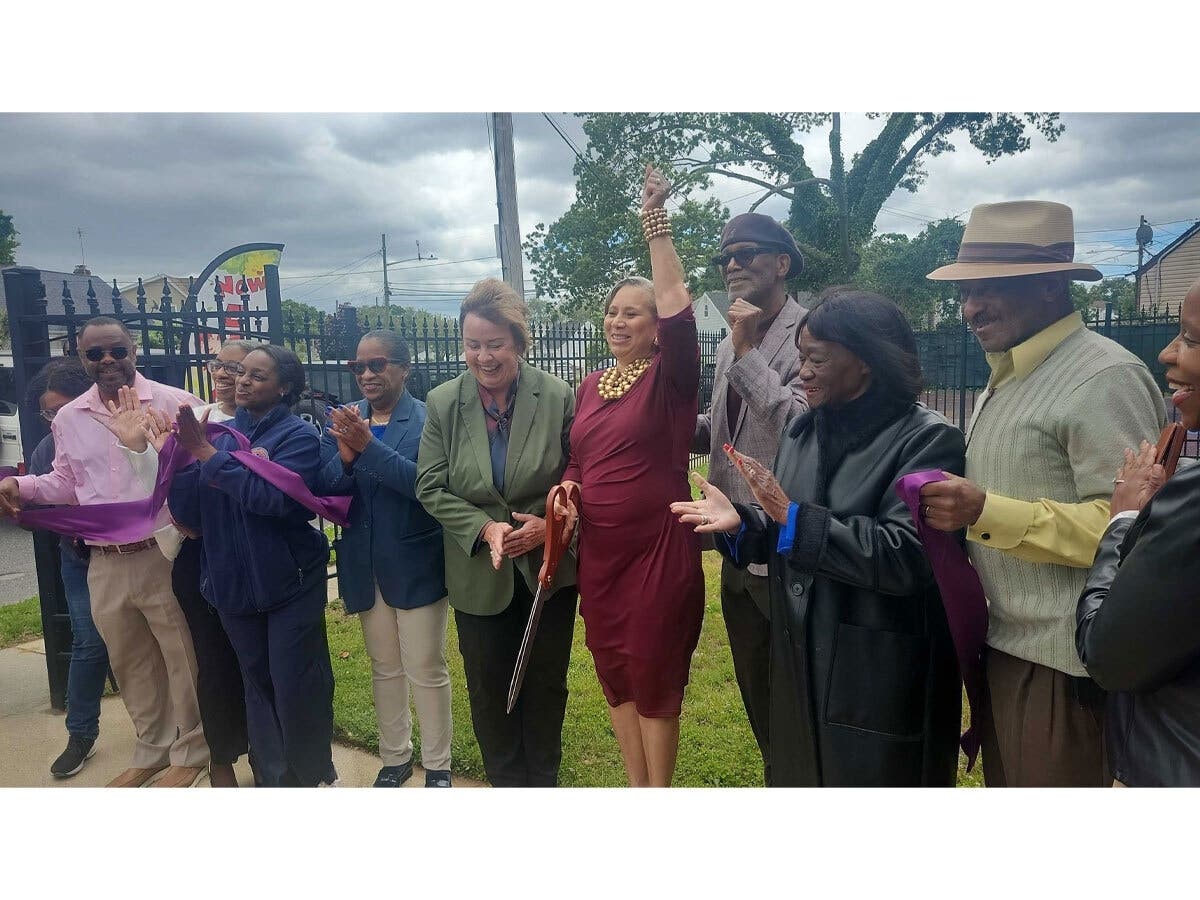 Linda Anderson, owner of Special Treasures Day Care, celebrated during the ribbon-cutting for the center’s new Uniondale location on May 30.