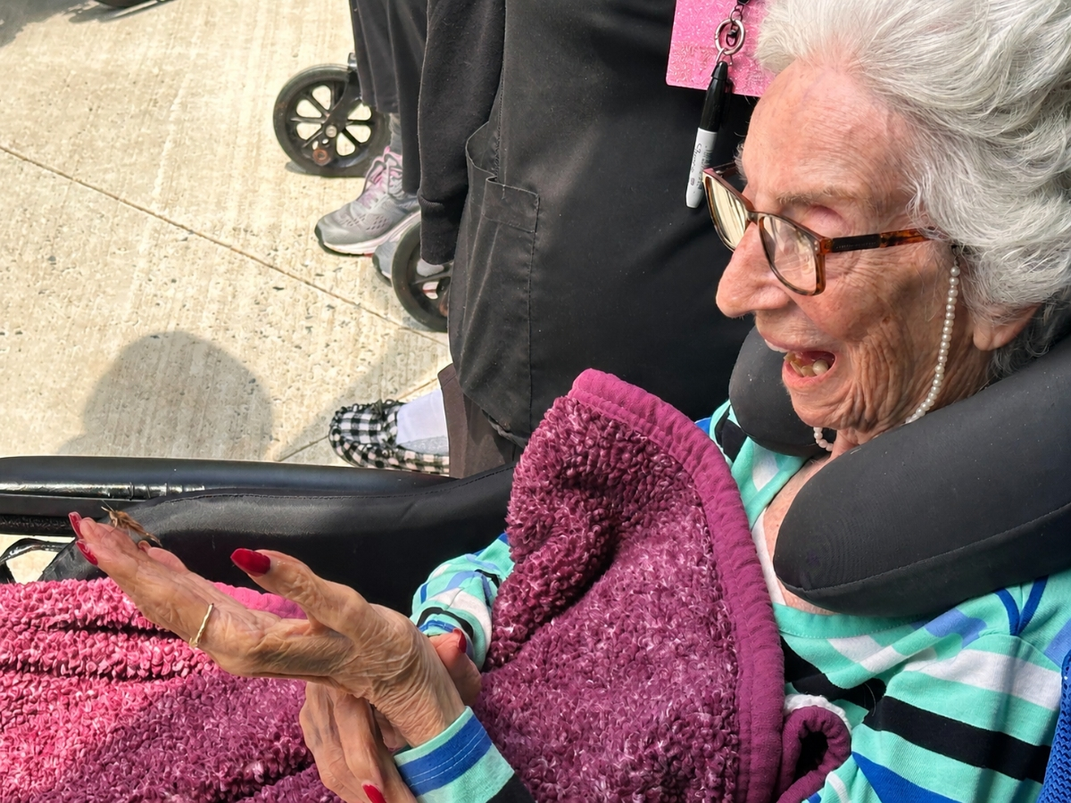A Momentum at South Bay resident smiles during the East Islip facility’s fourth annual “Celebration of Life” Butterfly Release. 