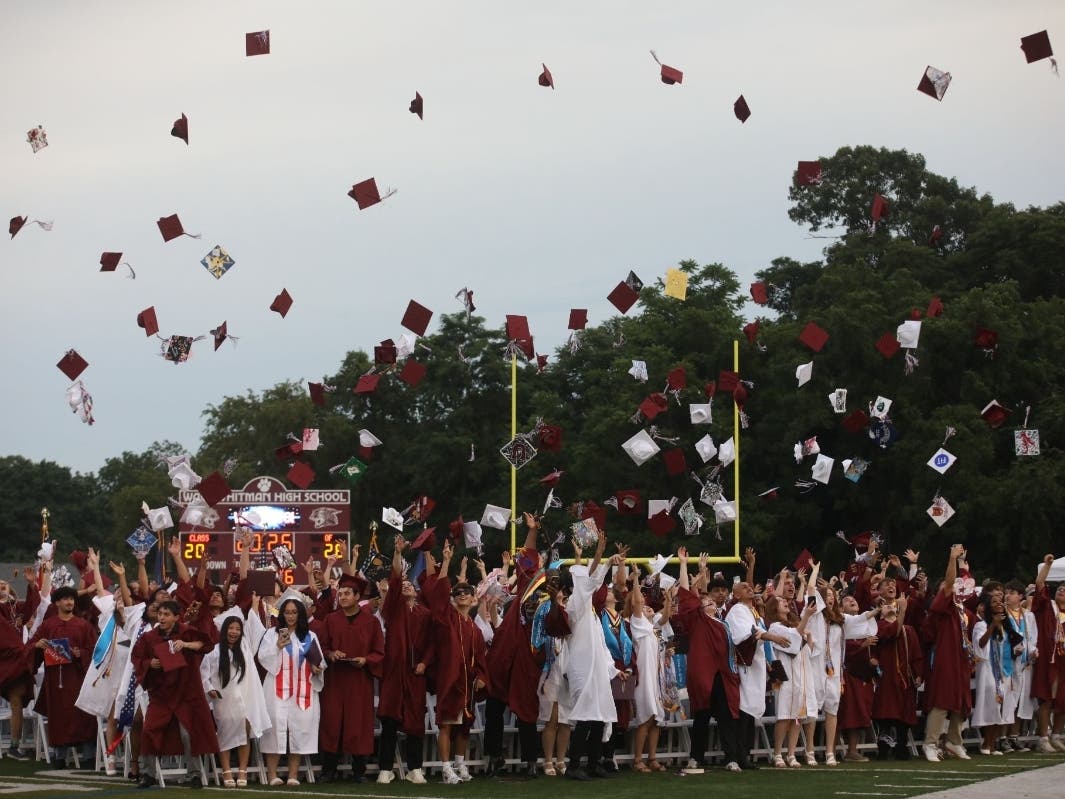 Walt Whitman High School’s Class of 2026 celebrates with the traditional cap toss at Wildcat Stadium.