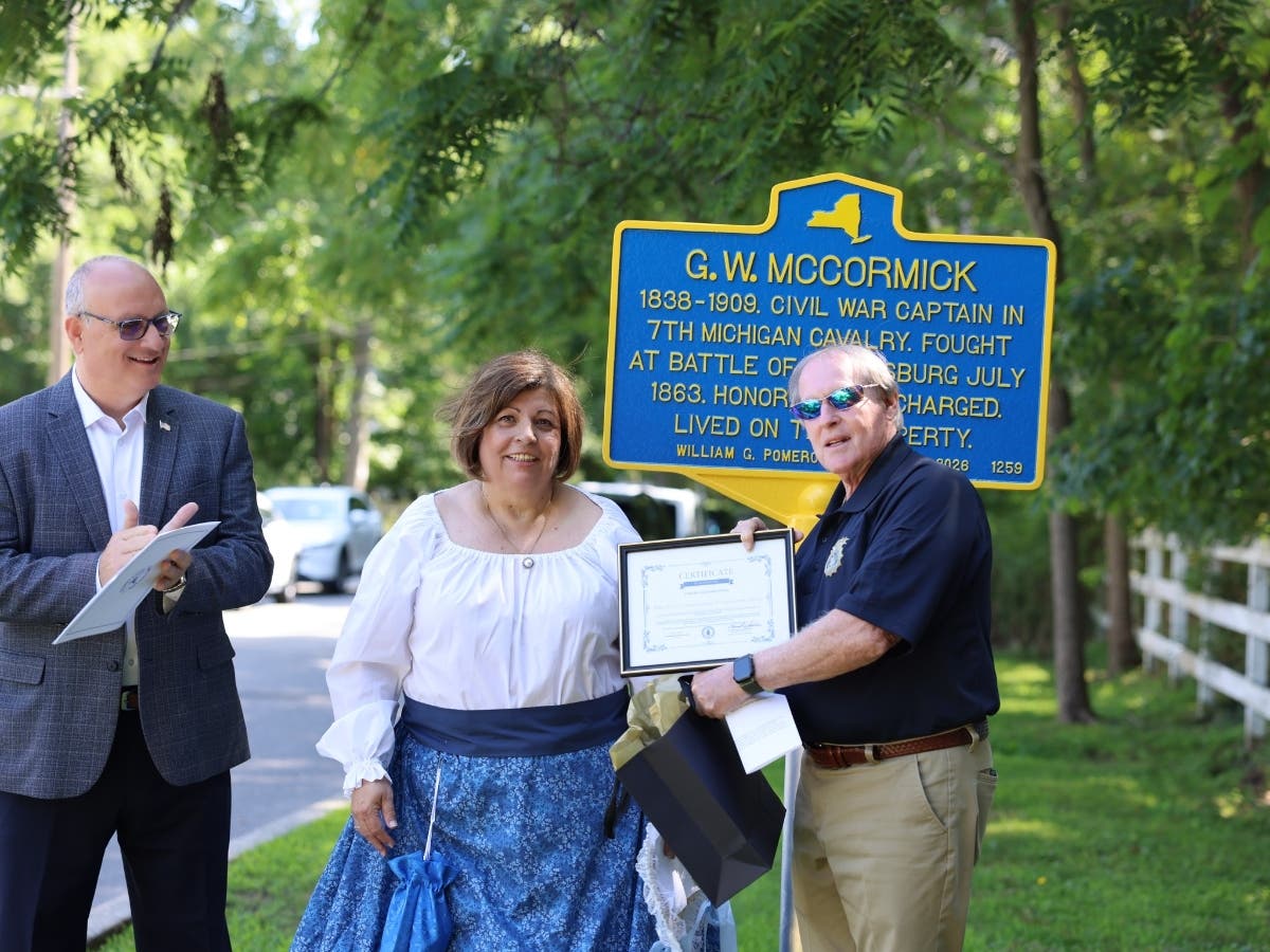 Town officials and members of the W.S. Commerdinger Jr. County Park Preservation Society celebrate the unveiling of a historical marker honoring Civil War Capt. George W. McCormick in Nesconset.